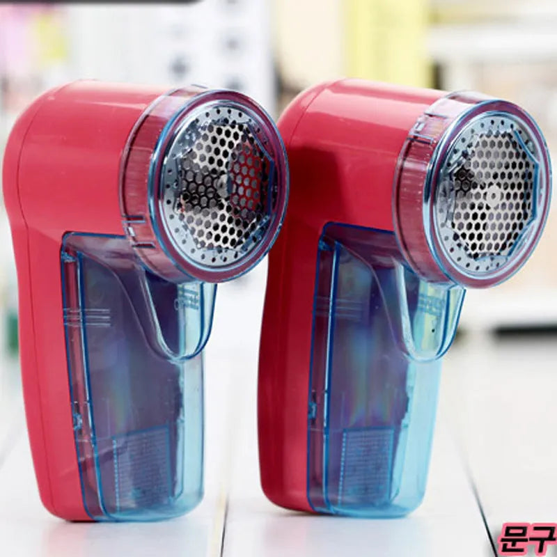 Blue portable electric lint remover for clothing, showing compact size next to a sweater.