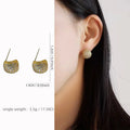 Little Golden Beans geometric drop earrings with spherical elements and diamond detailing in gold and white colours