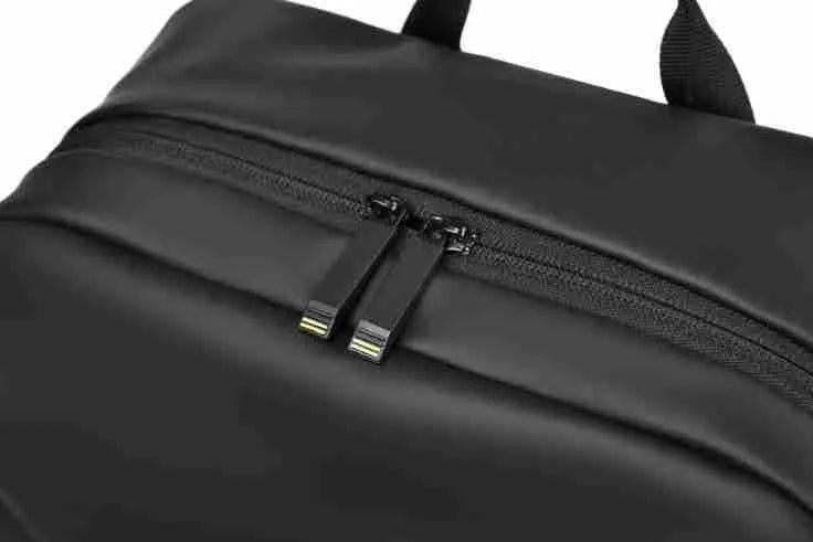 Waterproof laptop backpack in black showing large main compartment and simple design with sewing thread detailing