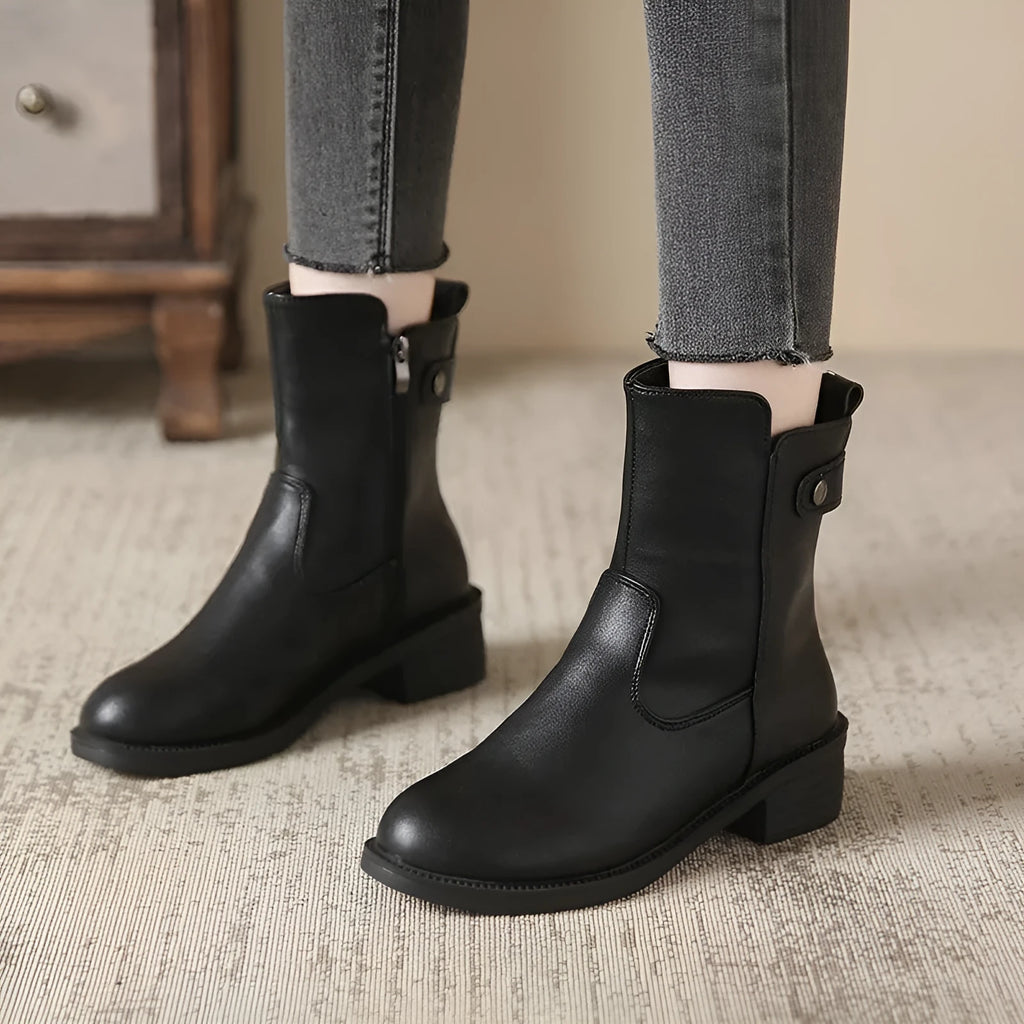 Black women's short boots with a low round toe and side zip, shown on a white background.