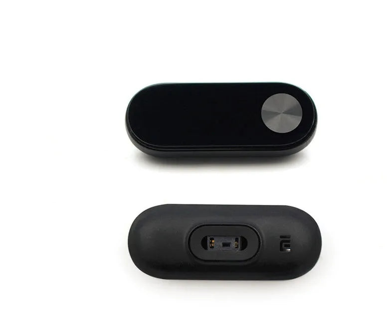 Xiaomi Mi Band 2 black smartband on wrist showing OLED display with heart rate and step count.