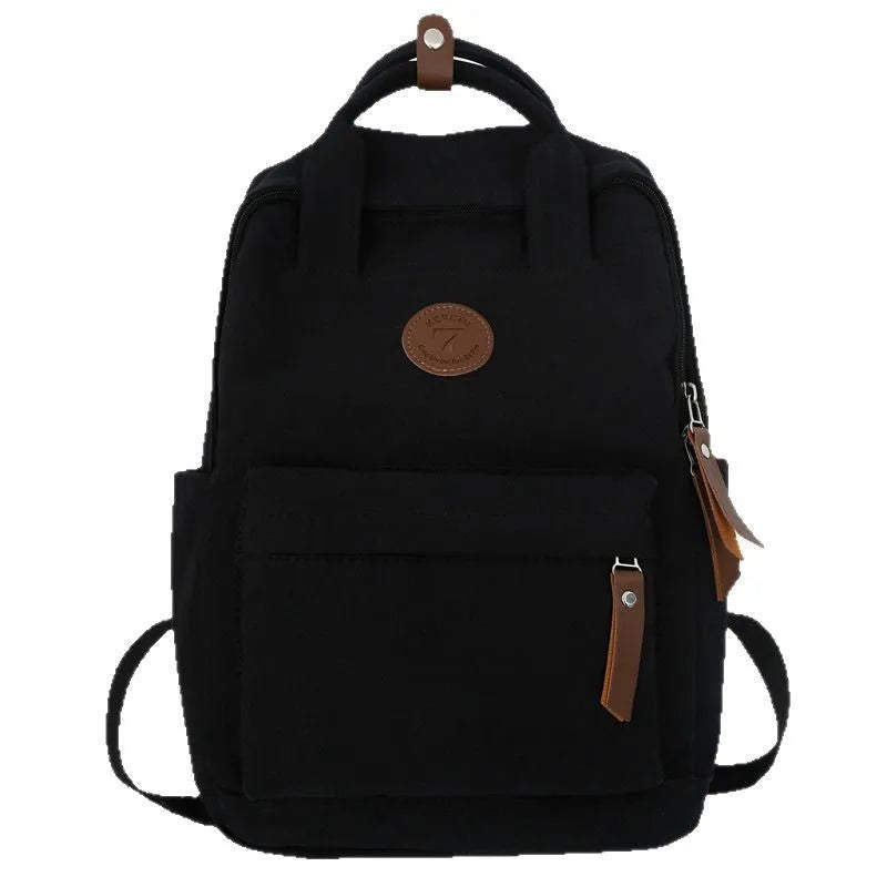 Black Oxford cloth fashion backpack with curved shoulder straps showing retro sewing thread details