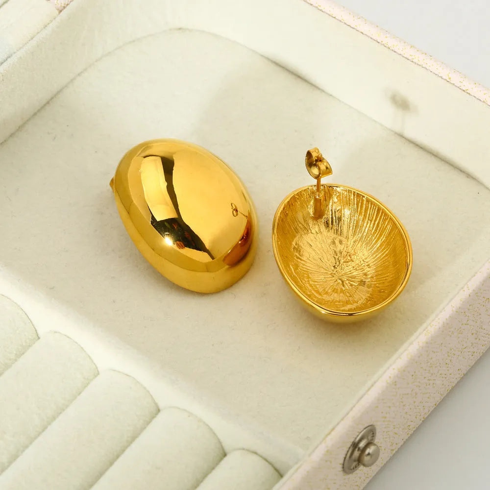 Geometric stainless steel ear studs with a glazed 18K gold electroplated finish and linear design details.