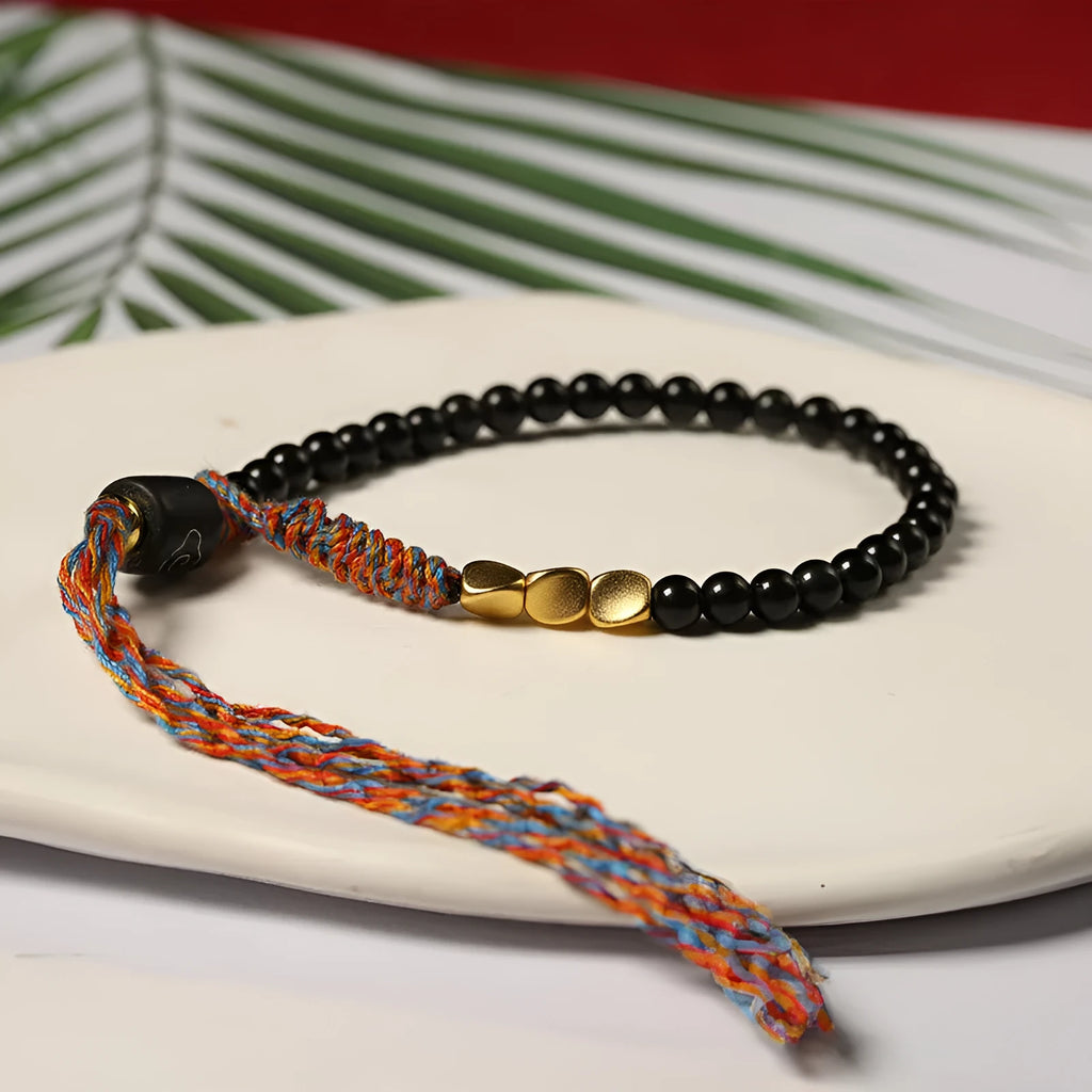 Hand-woven obsidian carrying strap bracelet showing braided detail and adjustable 15.5-16cm length