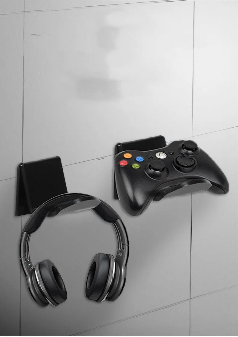 A universal plastic wall mount bracket for game controllers, shown in black, white, and transparent colour options.