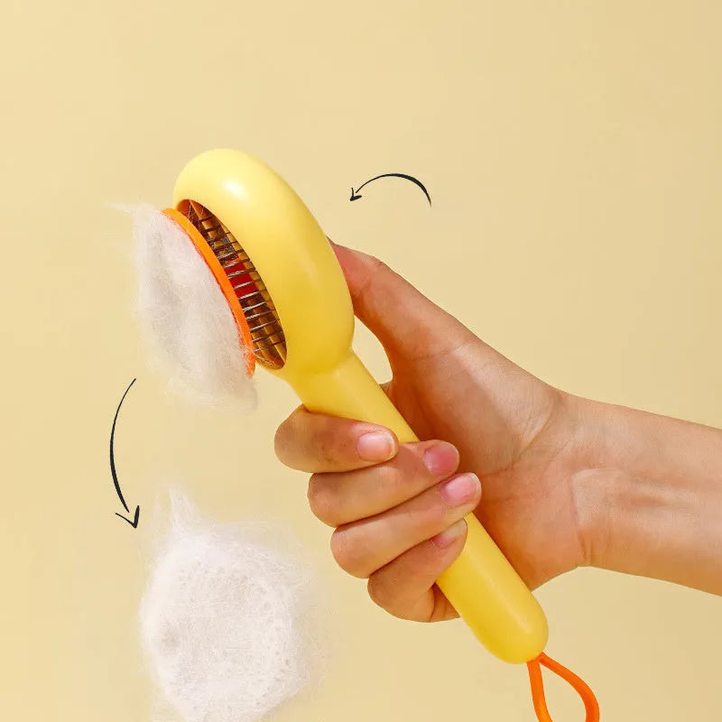Small yellow duck-shaped pet grooming comb with needle pins for cats and small dogs