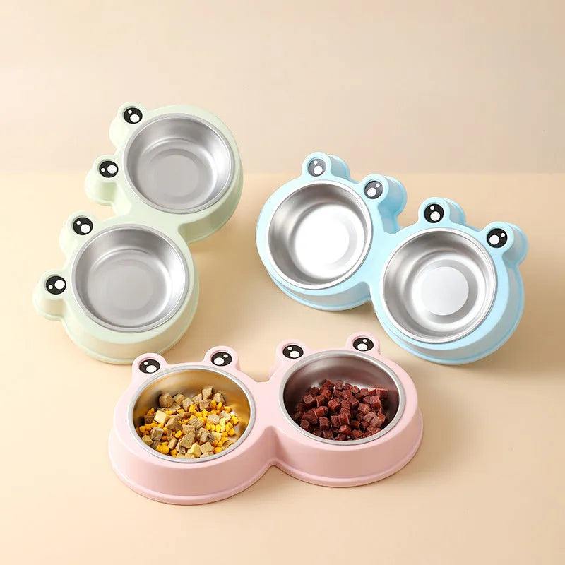 Stainless steel frog-shaped double bowl for pet food and water in blue, green, or pink.