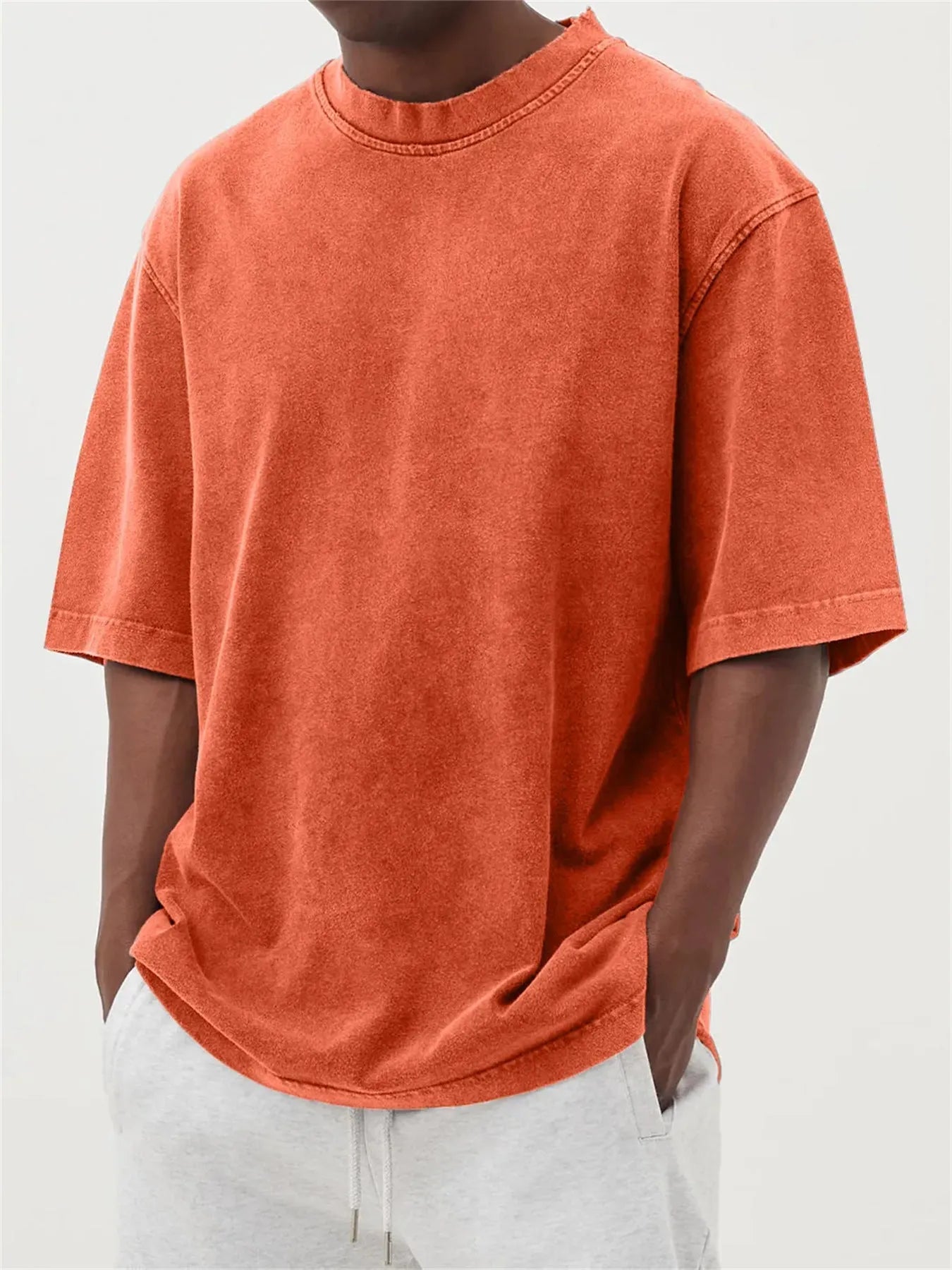Men's loose-fit stone-washed t-shirt in army green showing distressed texture and pullover style.