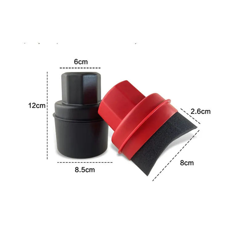Hand-held black and red car tyre polishing sponge brushes with lids on a garage workbench.