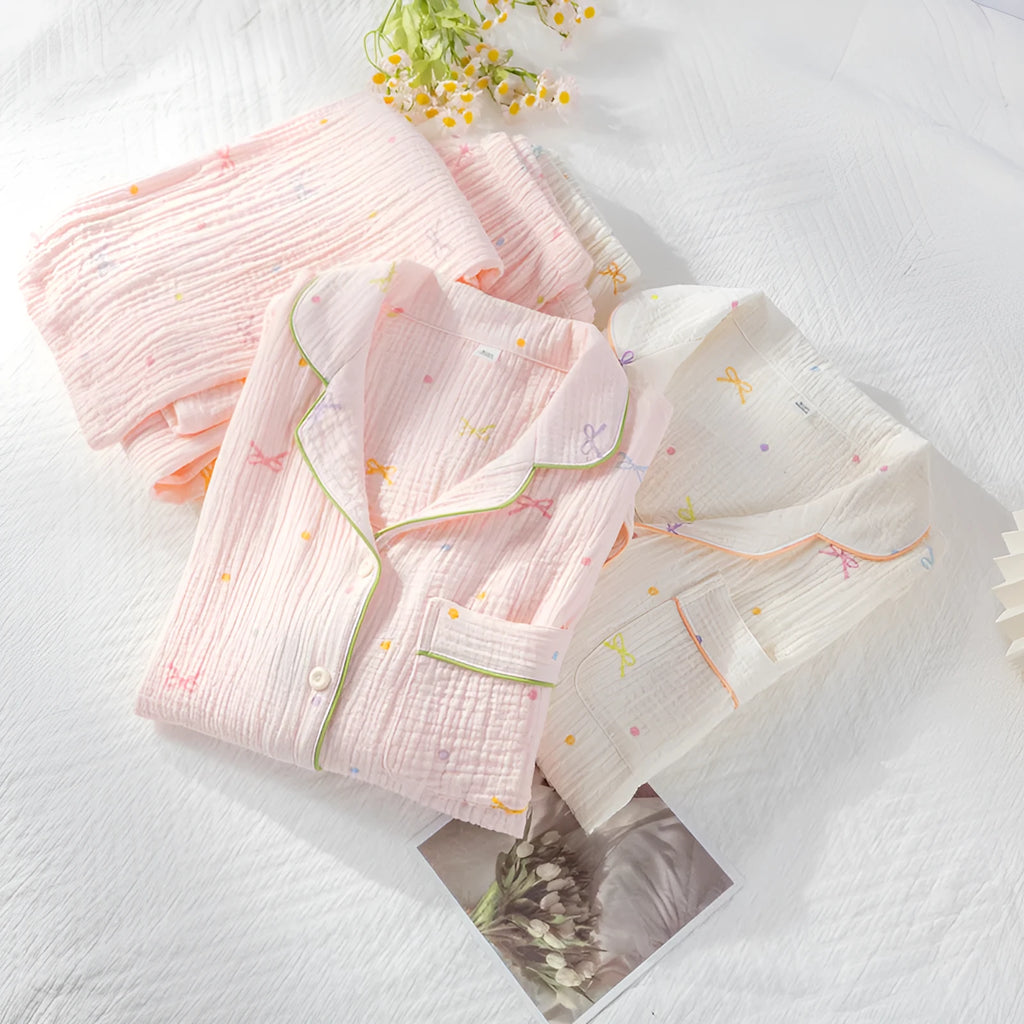 Women's thin cotton long-sleeved pajama set in pink, showing top and trousers laid flat.