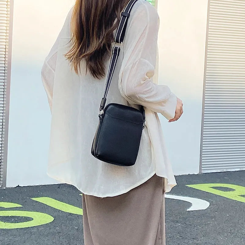 Solid colour small crossbody mobile phone bag in beige, showing front view and adjustable strap.