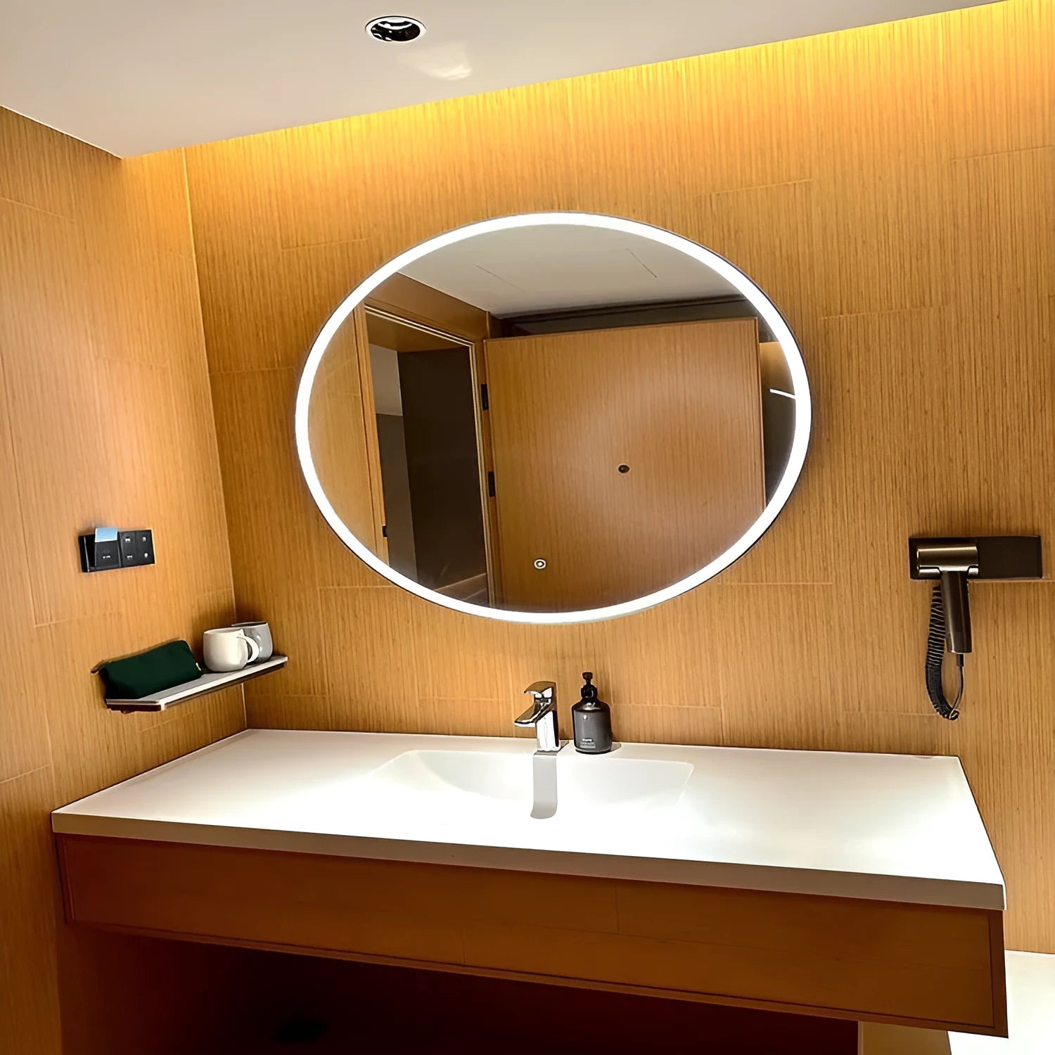 Round black aluminium frame LED bathroom mirror mounted on wall with touch control for dimmable lighting.