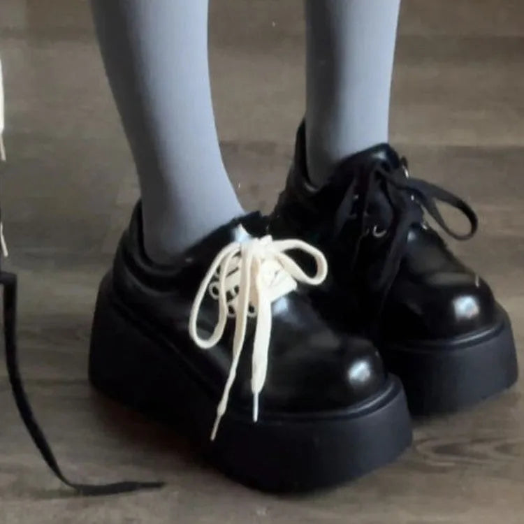 Women's matte black lace-up high heel shoes with a thick rubber sole and round toe.