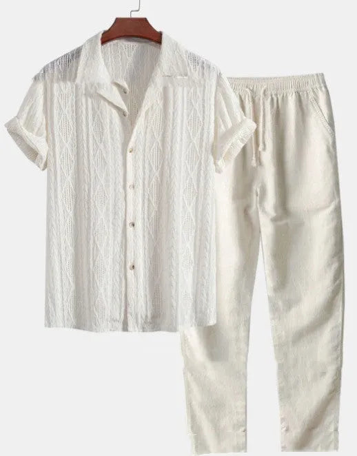 Man wearing a loose-fit light blue short sleeve shirt and matching trousers from a milk silk summer suit.