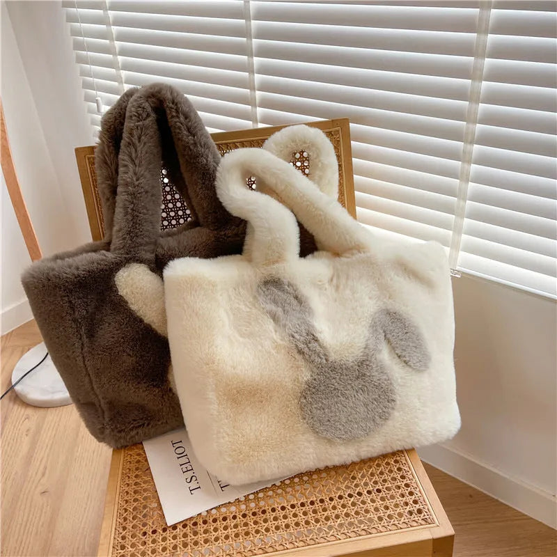 Soft plush shoulder bag with cartoon rabbit ears in one of six solid colours.