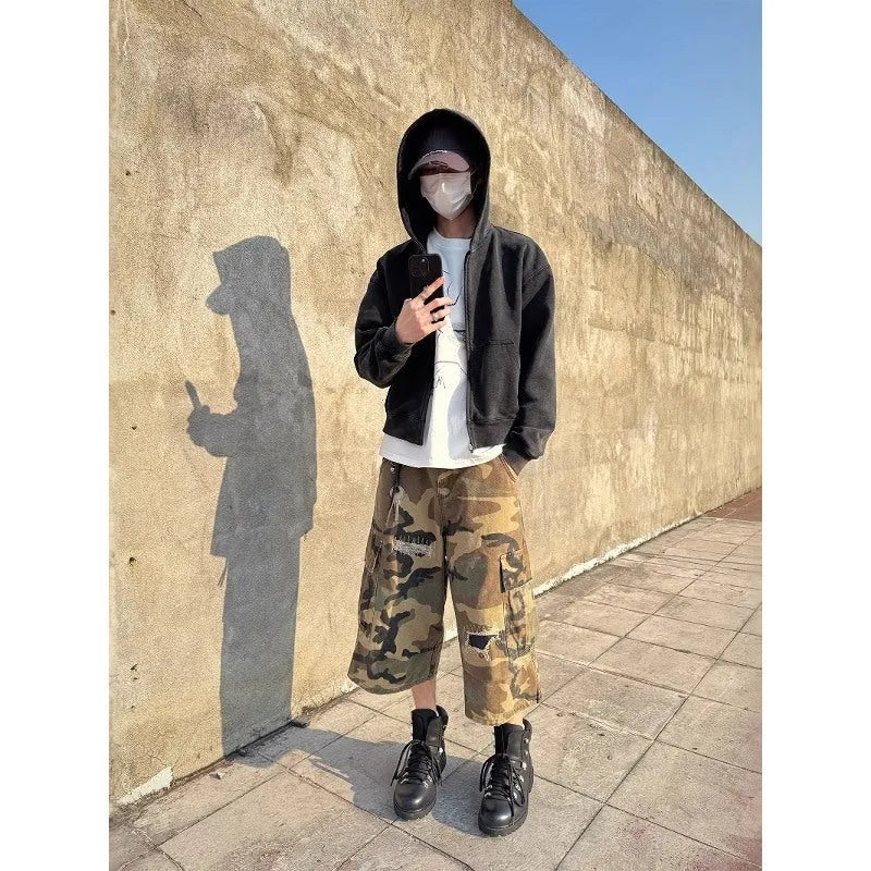 Men's camouflage cropped jeans with retro patches and ripped detailing on loose straight-leg trousers