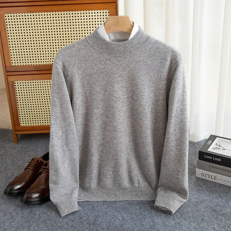 Man wearing a loose-fit half-collar wool sweater in a dark colour, showcasing the knitted texture and neckline design.