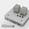 Compact white plastic USB keyboard with a touch panel and multimedia keys.