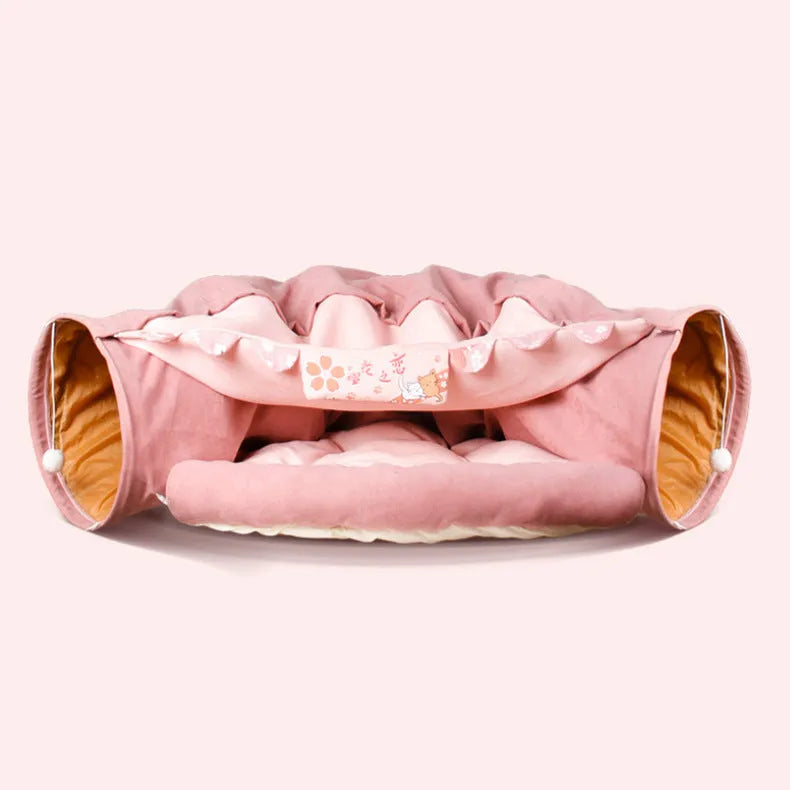Collapsible cloth cat tunnel toy in pink, shown folded flat and opened for play