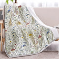 White Sherpa fleece blanket with tree leaf mushroom pattern, sized 130x150cm, on a sofa