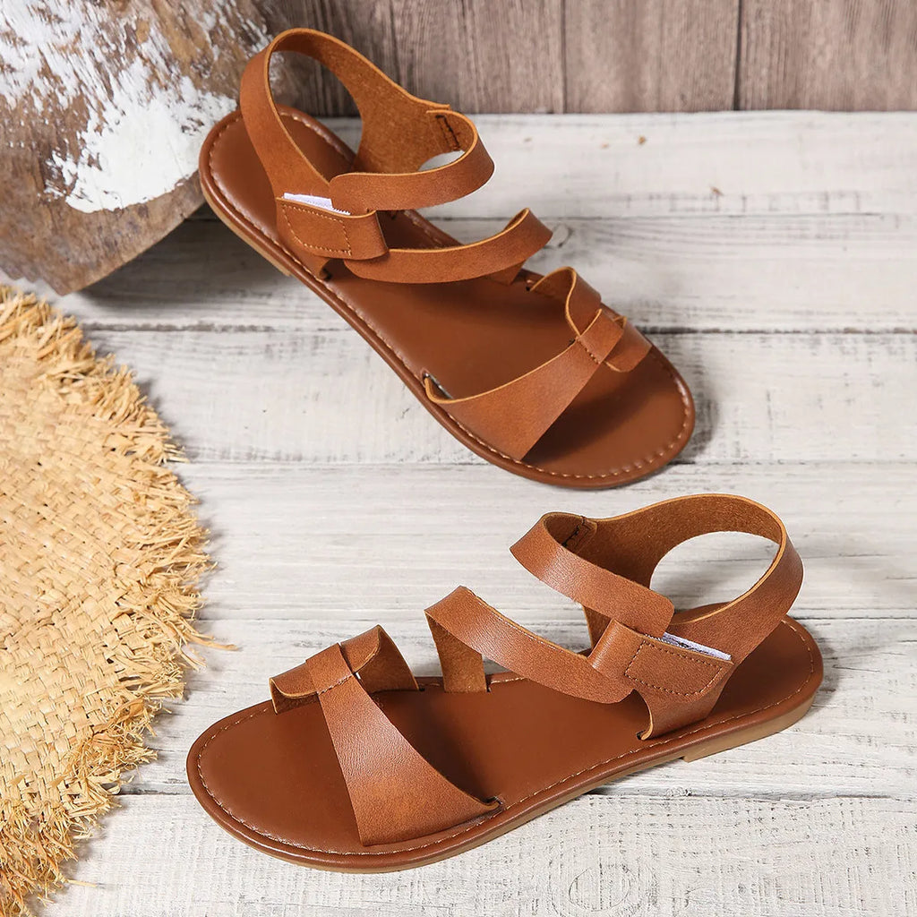 Women's flat sandals with Velcro strap in black, brown, and colourful on a rubber sole.