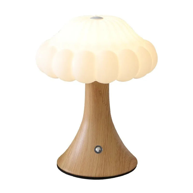 Small touch control rechargeable mushroom night light in wood grain colour on a table.