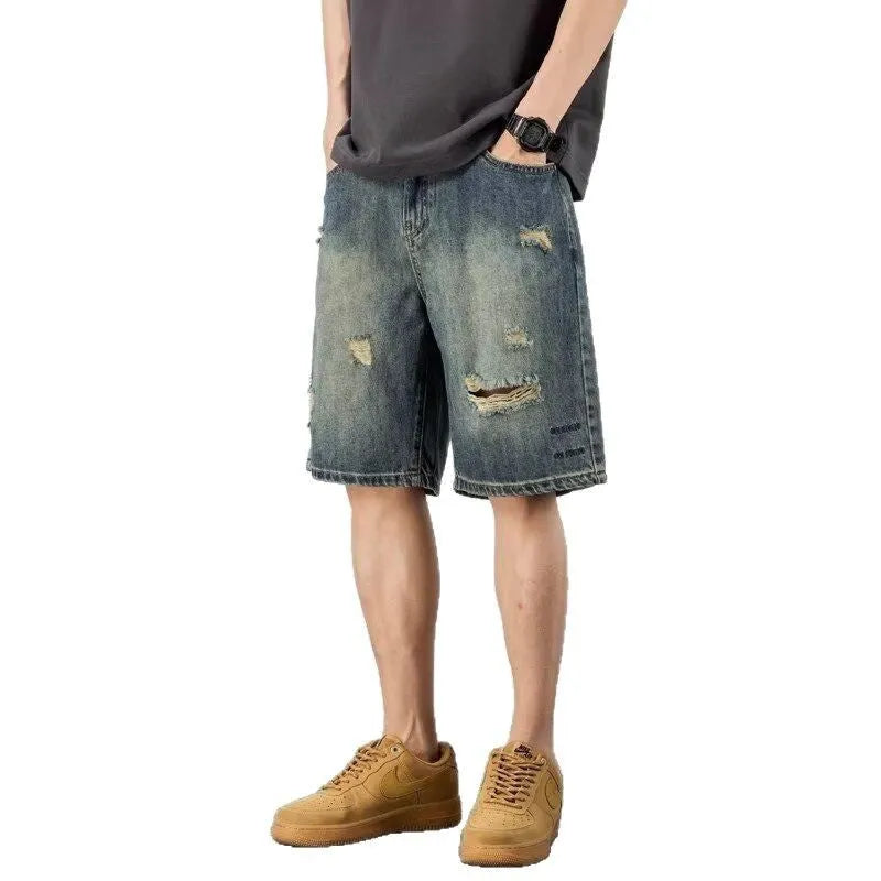 Blue distressed retro denim shorts for men on a white background