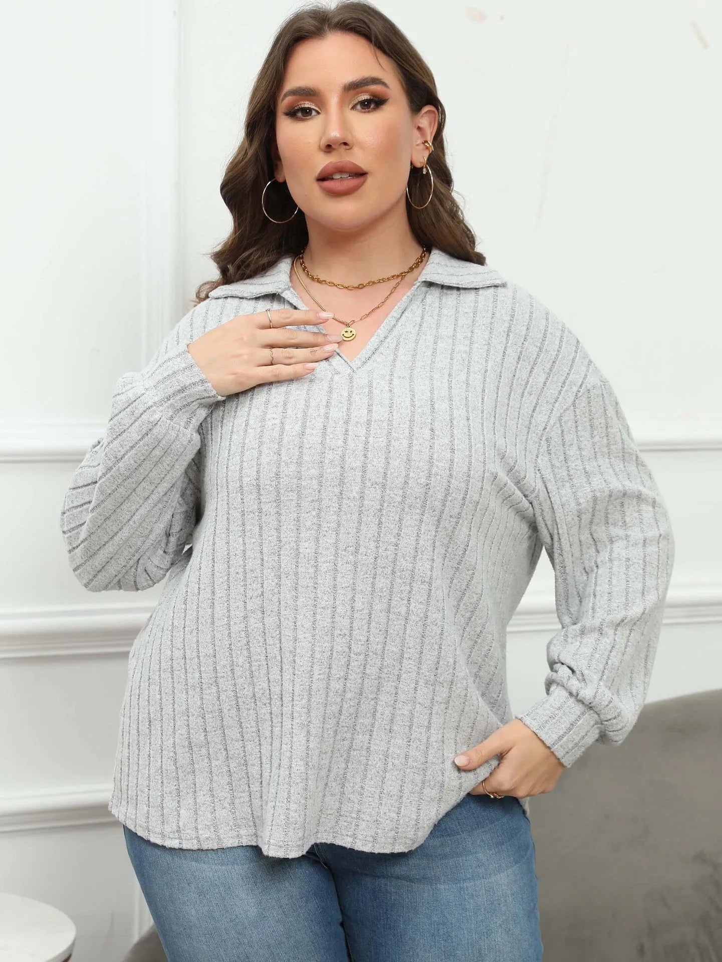 Women's plus size gray fleece pullover with a polo collar and full lantern sleeves.