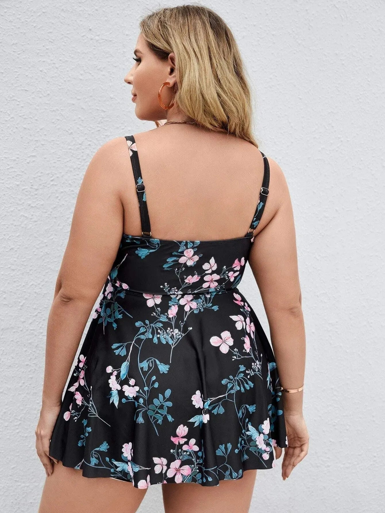 Women's one-piece swimsuit with a split colour floral print, shown in an extended size.