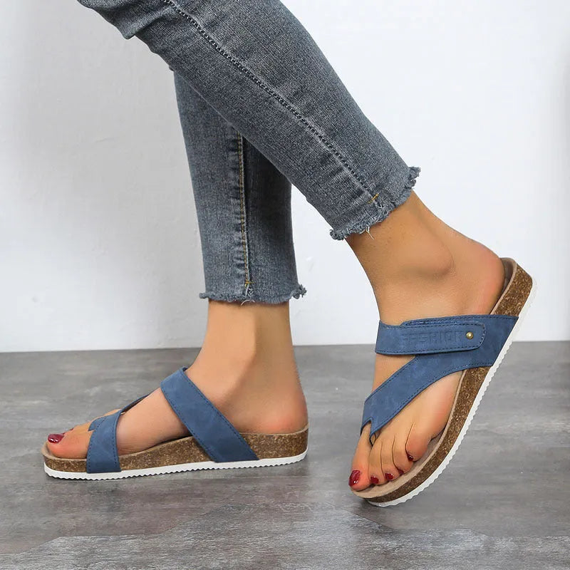 Flat toe ring thick-soled flip-flops in a solid colour on a light background