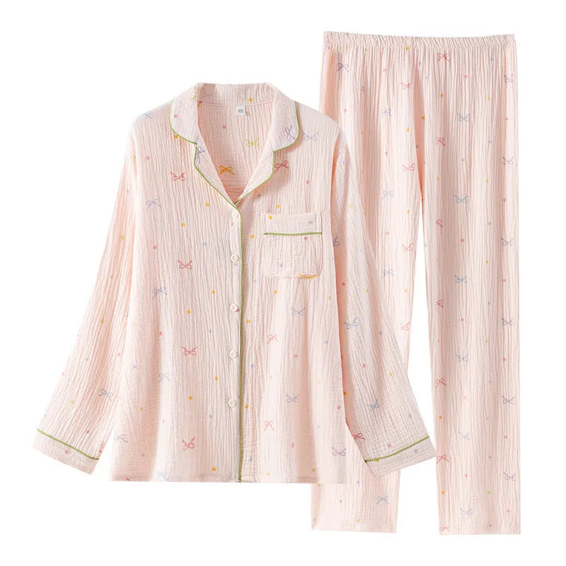 Women's thin cotton long-sleeved pajama set in pink, showing top and trousers laid flat.