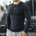 Men's black slim-fit fitness tights with long sleeves for gym and running.