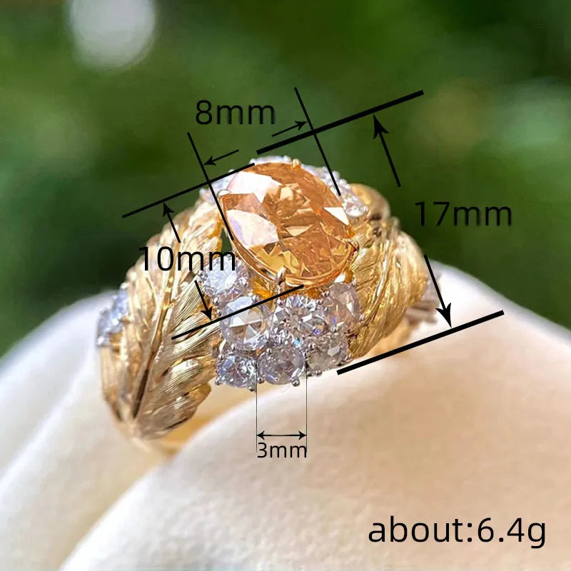 Gold colour copper ring with embossed feather design and inlaid yellow zircon stones.