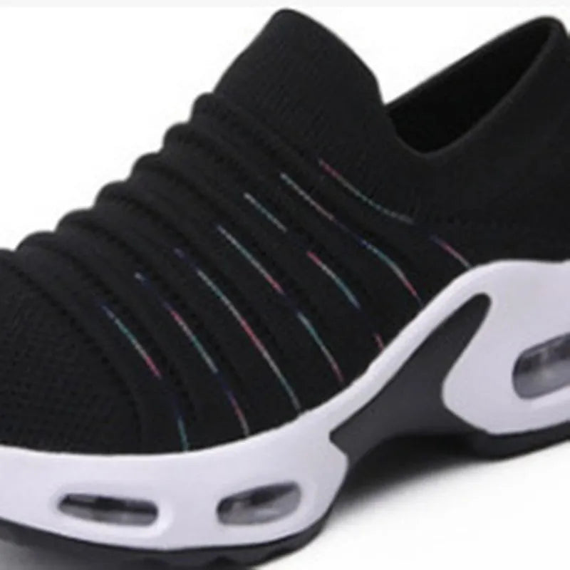 Women's plus size fly-knit socks shoes in dark blue with mesh upper and low heel, showing round toe design.