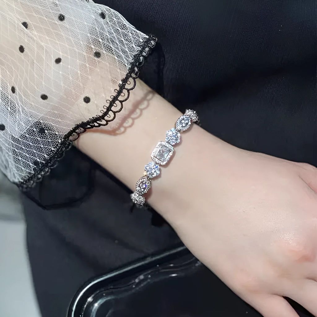 Women's geometric bracelet with zircon stones on silver-toned band showing adjustable and fixed length options
