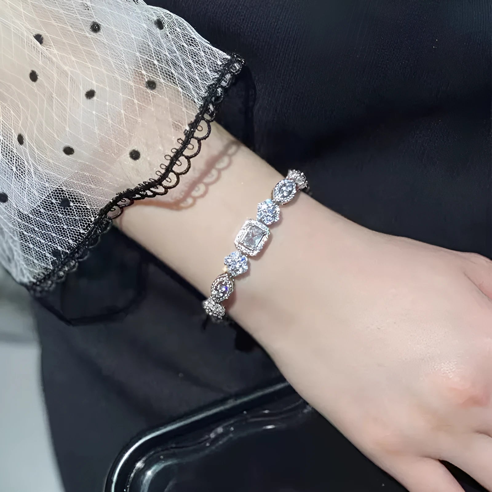 Women's geometric bracelet with zircon stones on silver-toned band showing adjustable and fixed length options