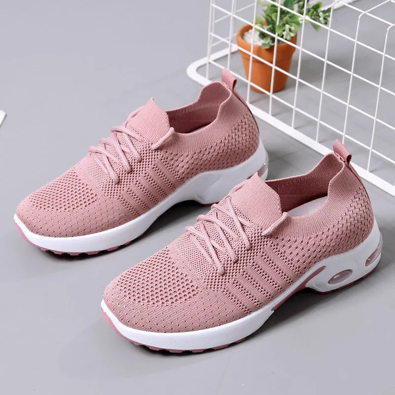 Women's black mesh casual sneakers with round toe and white lace-up front on a grey PVC sole.