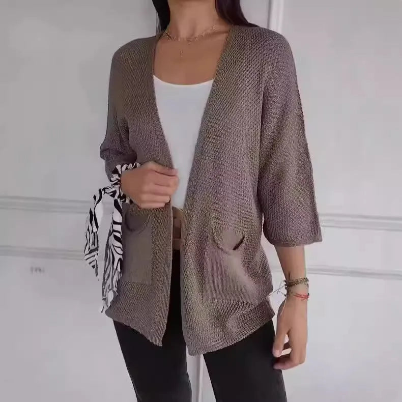 Women's thin waffle weave cardigan coat in army green with pockets, shown on a hanger.