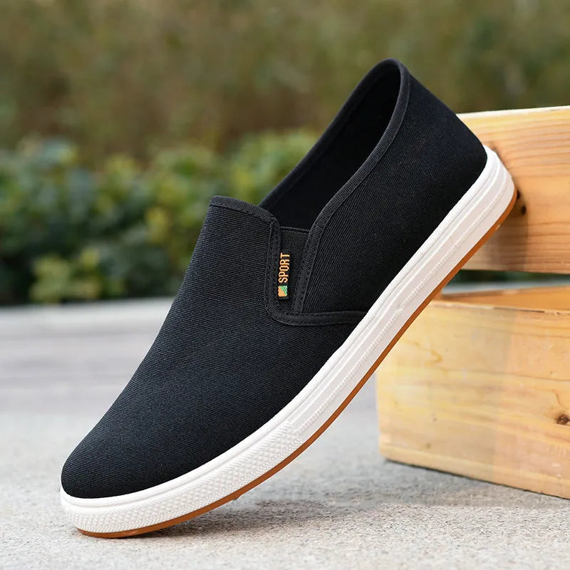 Men's black canvas slip-on shoes with round toe and low-top design