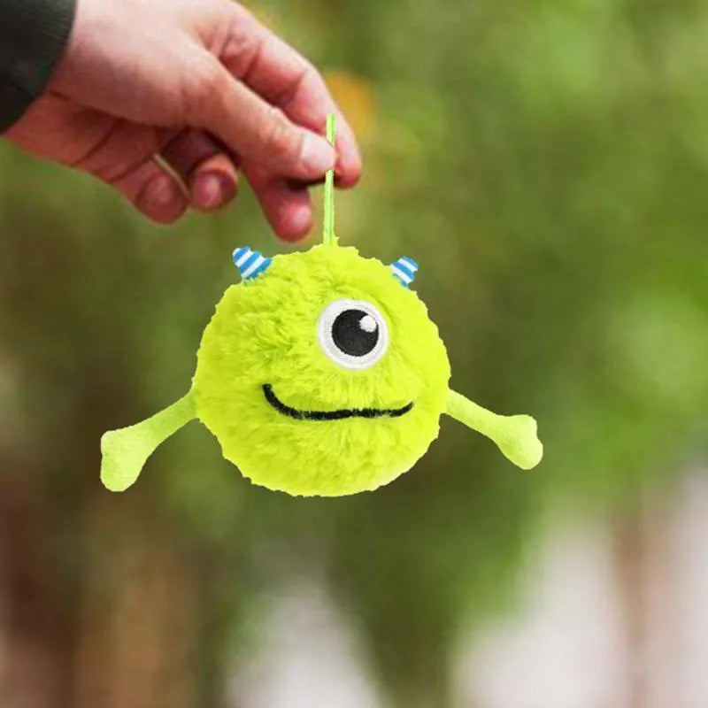 Green plush and TPR sound-activated interactive dog teething toy ball, 12cm diameter.