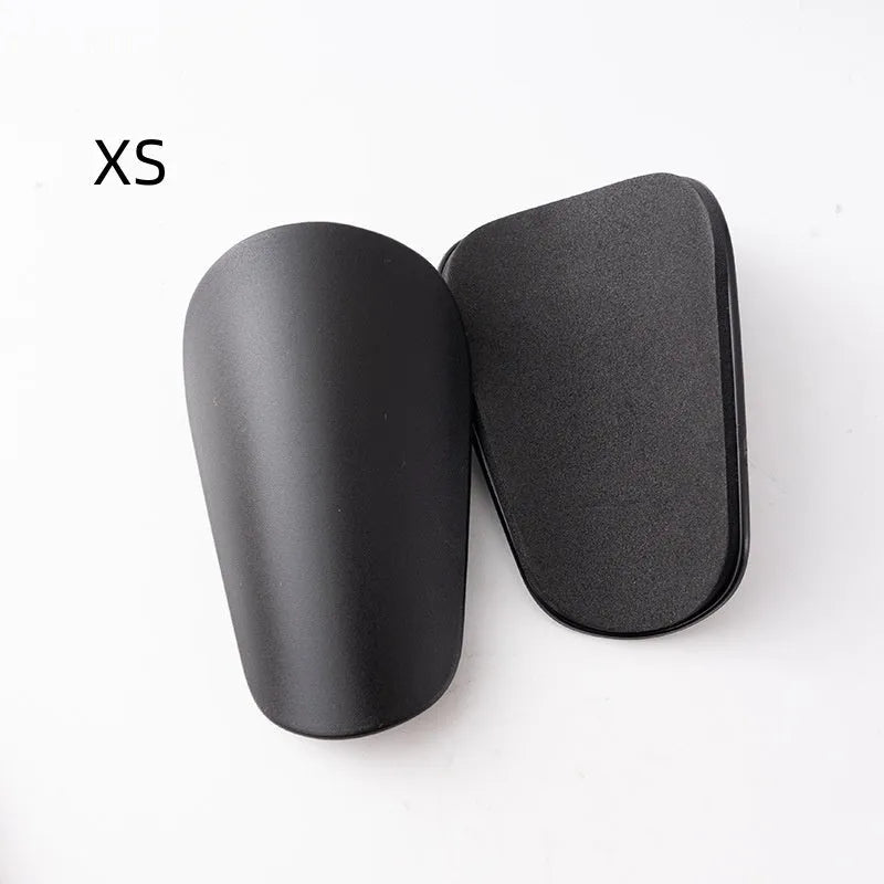 Pair of black PU mini shin guards for sports protection, showing S size.