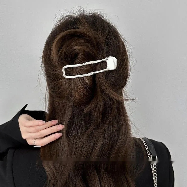Gold and silver zinc alloy hair barrettes in square, arc, and triangle shapes.
