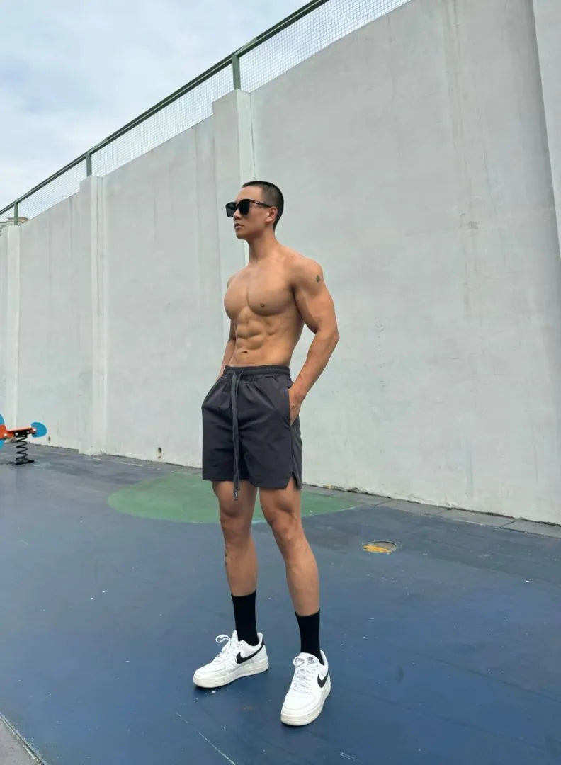 Men's quick-drying double-layer nylon shorts shown in multiple colours.