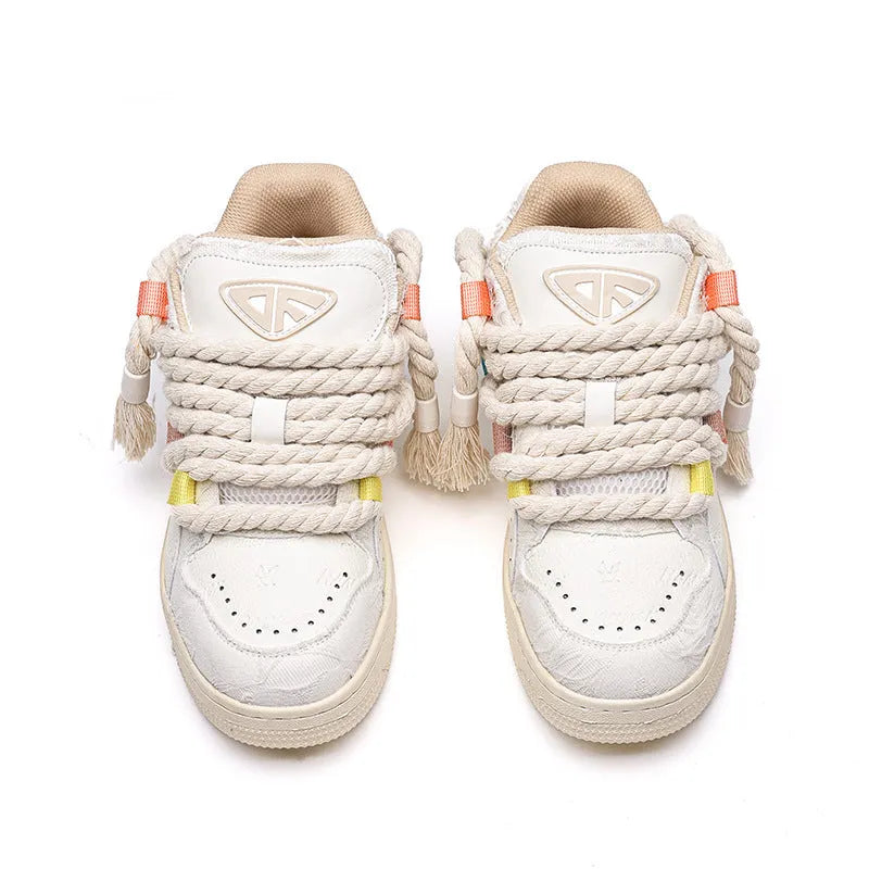 Creamy white low-top retro skate shoes with lace-up front and platform sole.