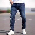 Men's dark blue slim-fit skinny casual jeans on a neutral background