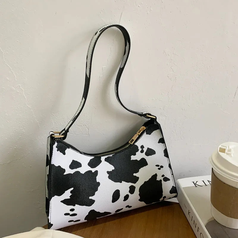 Women's small square underarm bag in PU leather, shown in multiple colour options including leopard print.
