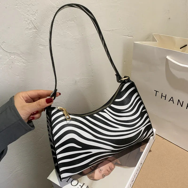 Women's small square underarm bag in PU leather, shown in multiple colour options including leopard print.