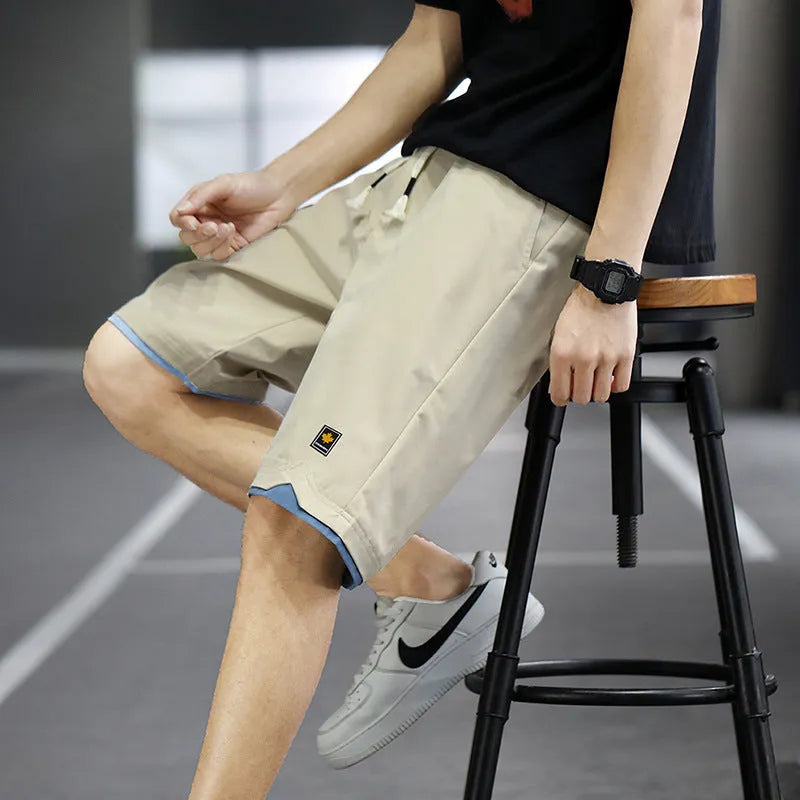 Man wearing loose-fit green casual beach shorts in a South Korea style, showing the straight cut and relaxed fit.