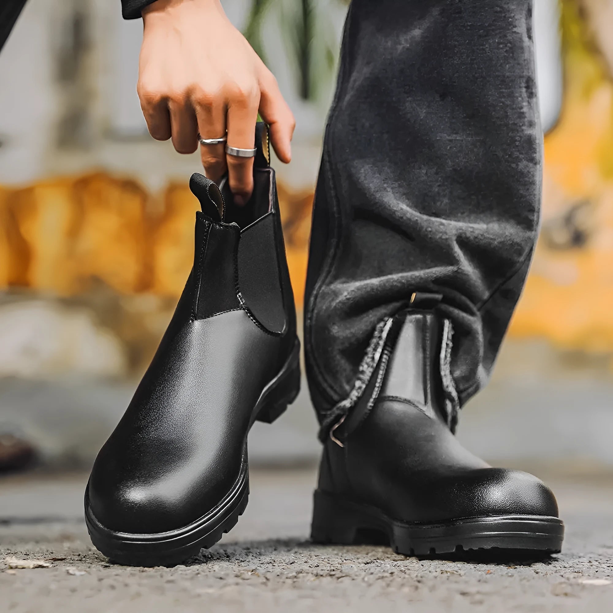 Vintage frosted brown leather Chelsea boot with round toe and low heel on a wooden surface.