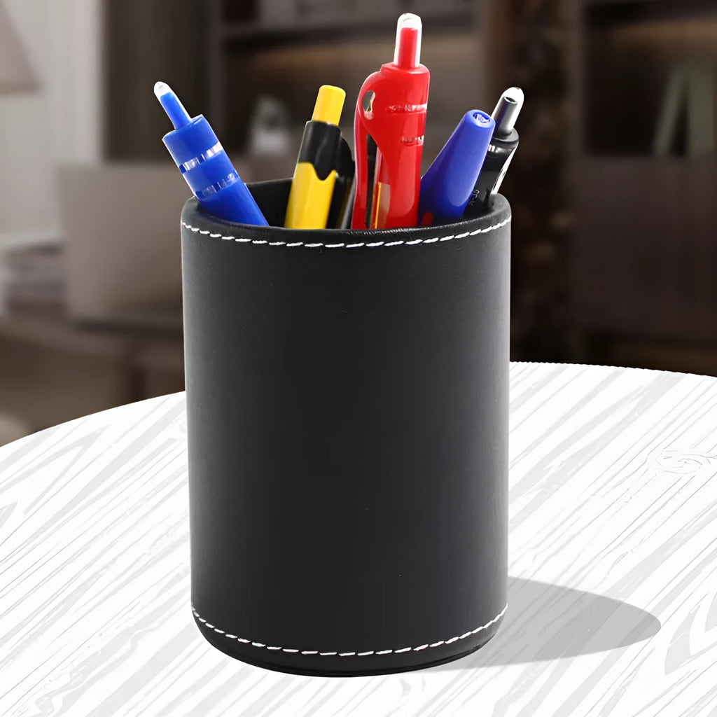 Round black leather pen container showing cylindrical shape and compact size for desk organisation.